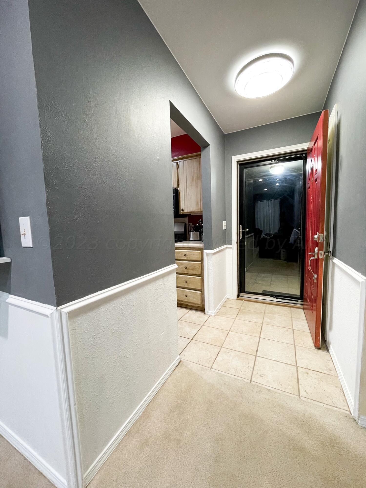 5317 Capulin Lane Amarillo, TX 79110 - Photo 14 of 19 a view of a hallway with wooden floor and furniture