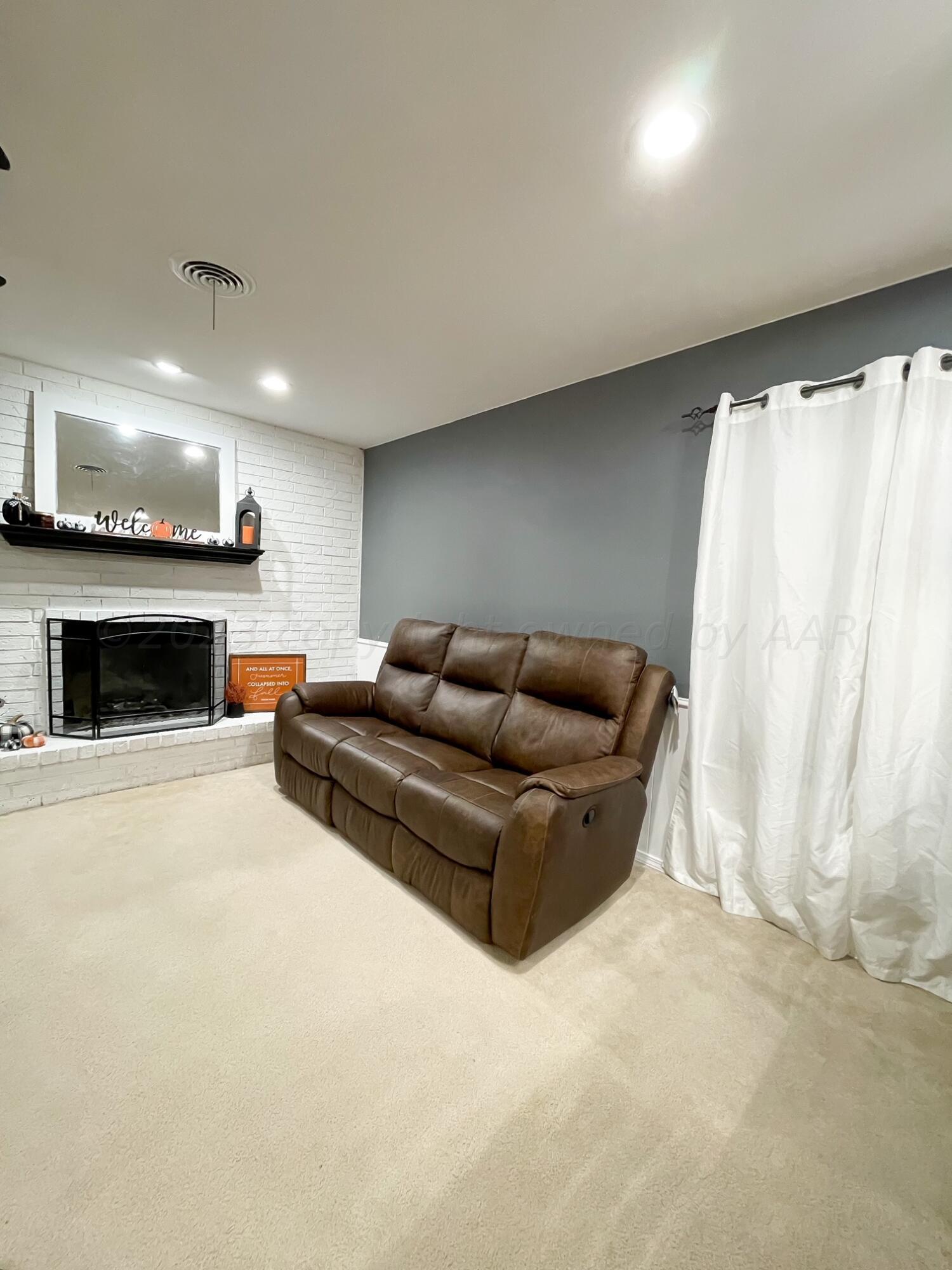 5317 Capulin Lane Amarillo, TX 79110 - Photo 3 of 19 a living room with furniture and a fireplace