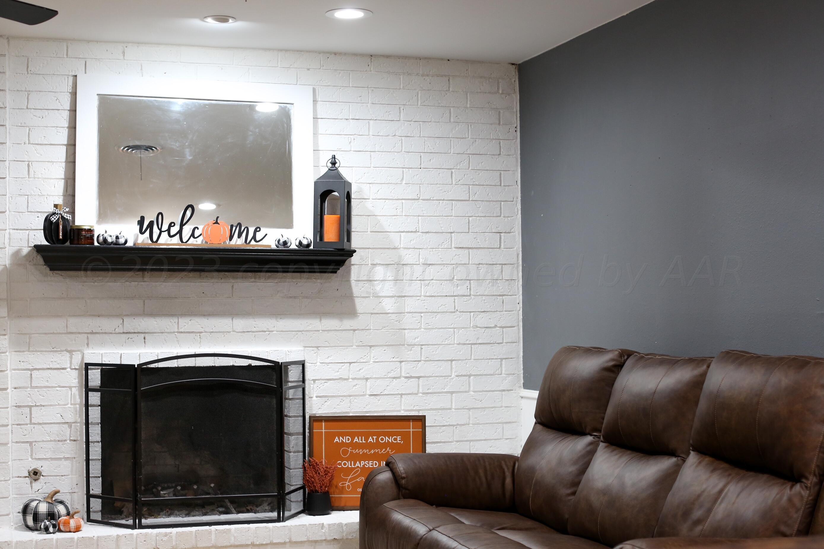 5317 Capulin Lane Amarillo, TX 79110 - Photo 4 of 19 a living room with furniture and a fireplace