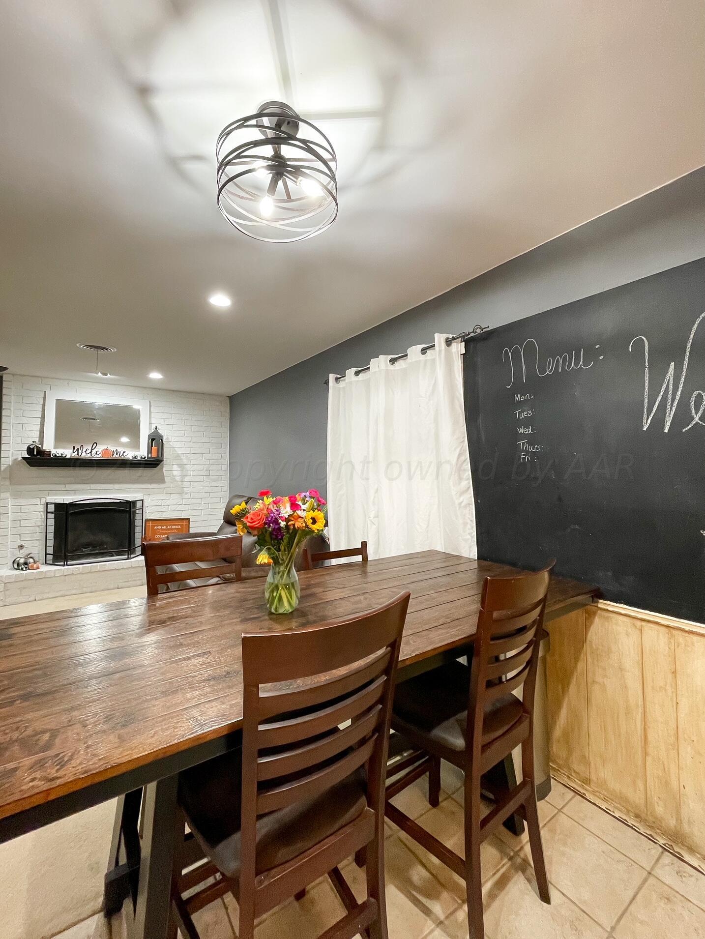 5317 Capulin Lane Amarillo, TX 79110 - Photo 7 of 19 a view of a dining room with furniture and a chandelier
