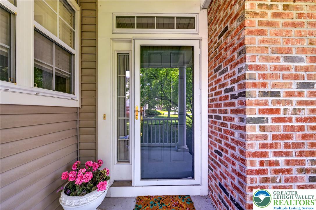4345 Creek Road Allentown, PA 18104 - Photo 4 of 33 A welcoming entry, with a classic storm door, brick and siding exterior.