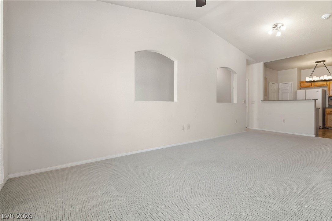 10550 West Alexander Road, Unit 2060 Las Vegas, NV 89129 - Photo 14 of 45 A spacious living area flows into the kitchen, ideal for entertaining.