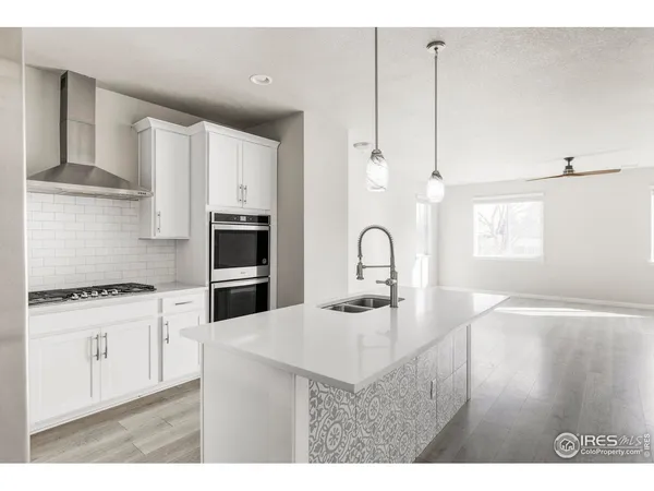 a kitchen with granite countertop a stove and cabinets