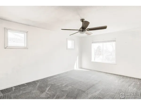 a kitchen with kitchen island a stove a sink a refrigerator and white cabinets with wooden floor