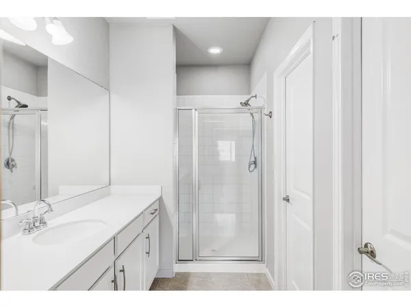 a room with a window wooden floor and a ceiling fan