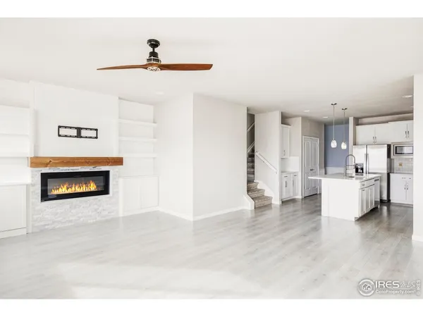 a living room with a fireplace and a painting on the wall