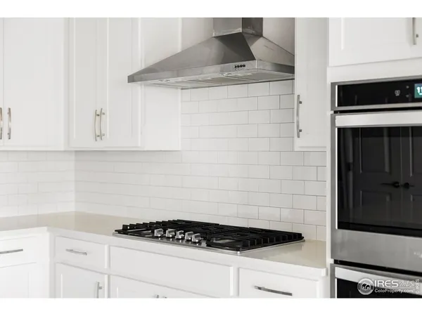 a kitchen with stainless steel appliances kitchen island a sink stove and refrigerator