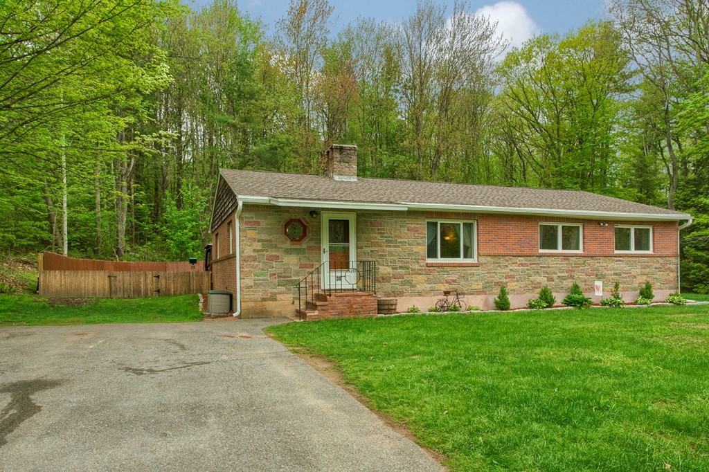 30 Center Street Ashburnham, MA 01430 - Photo 2 of 30 a front view of a house with a yard and trees