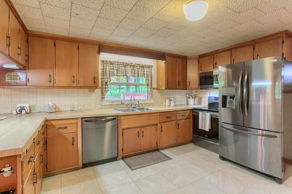 30 Center Street Ashburnham, MA 01430 - Photo 6 of 30 a kitchen with a sink window and refrigerator