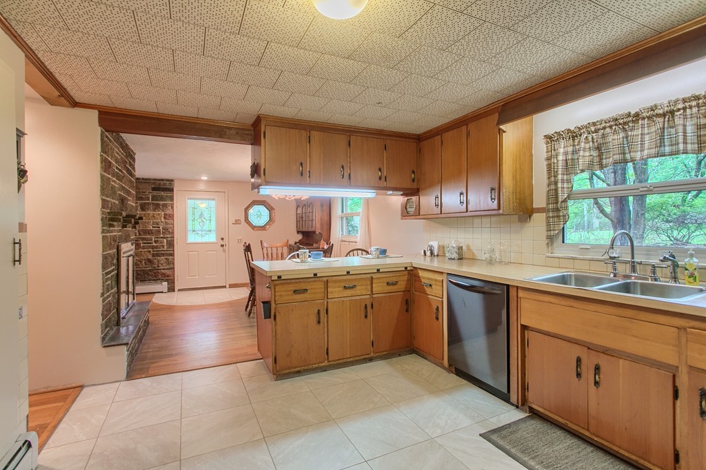 30 Center Street Ashburnham, MA 01430 - Photo 8 of 30 a kitchen with a sink window and cabinets