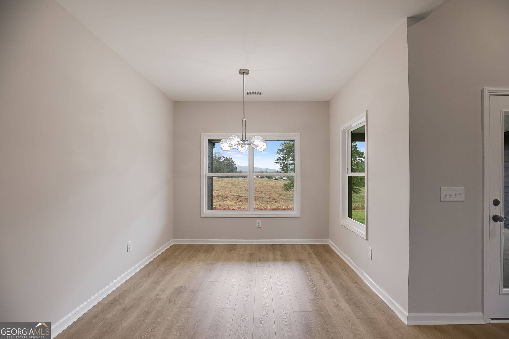 3356 Veal Road Roopville, GA 30170 - Photo 11 of 45 an empty room with wooden floor and windows