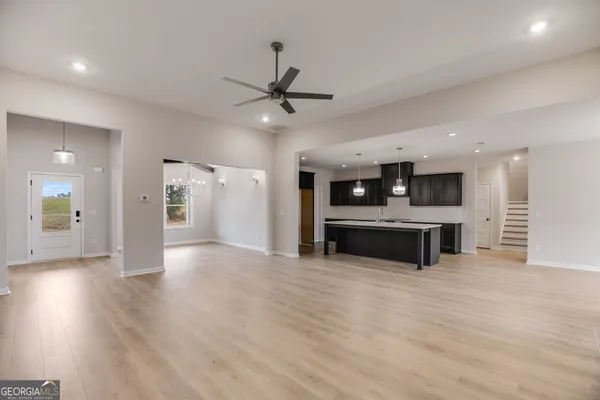 a kitchen with a sink cabinets and wooden floor