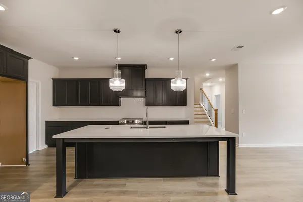 a kitchen with a sink a counter space and stainless steel appliances