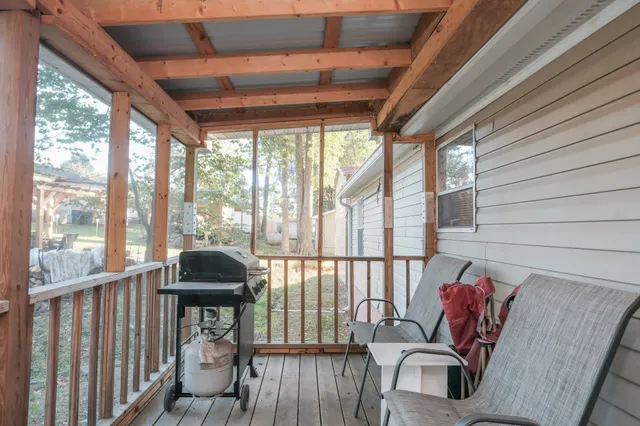 a view of a porch with furniture and a yard