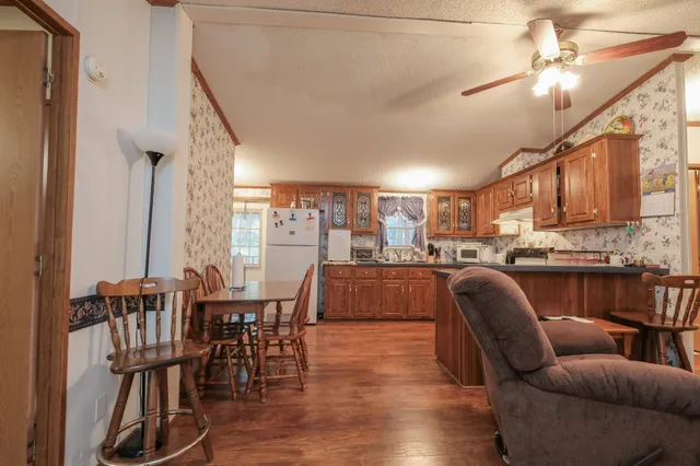 a living room with furniture and kitchen view