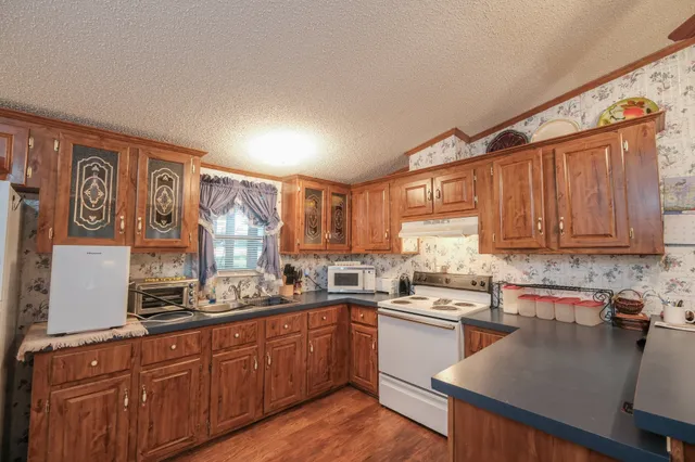 a kitchen with a sink cabinets counter top space and stainless steel appliances
