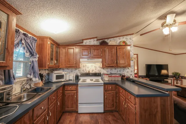 a kitchen with a sink stove and cabinets