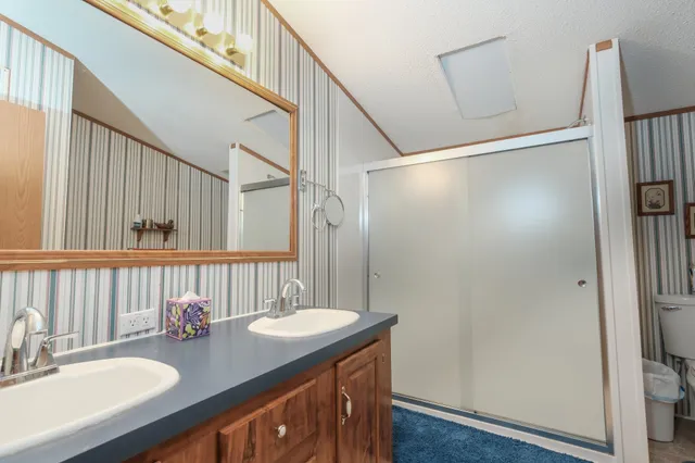 a bathroom with a sink double vanity and a mirror