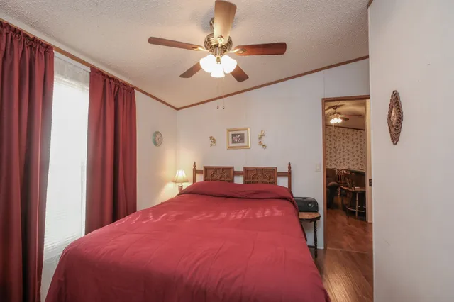 a bedroom with a bed and a chandelier