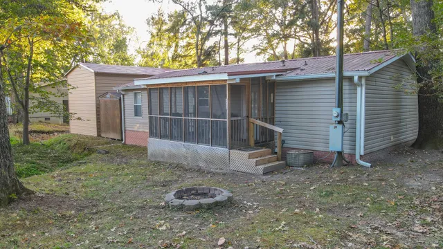 a view of a small house with a yard