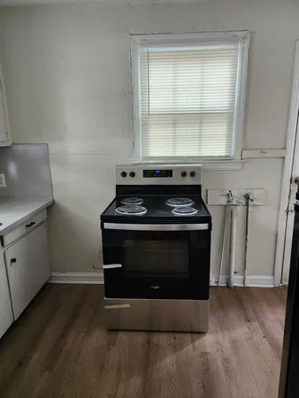 a stove top oven sitting inside of a kitchen