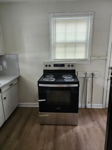 a stove top oven sitting inside of a kitchen