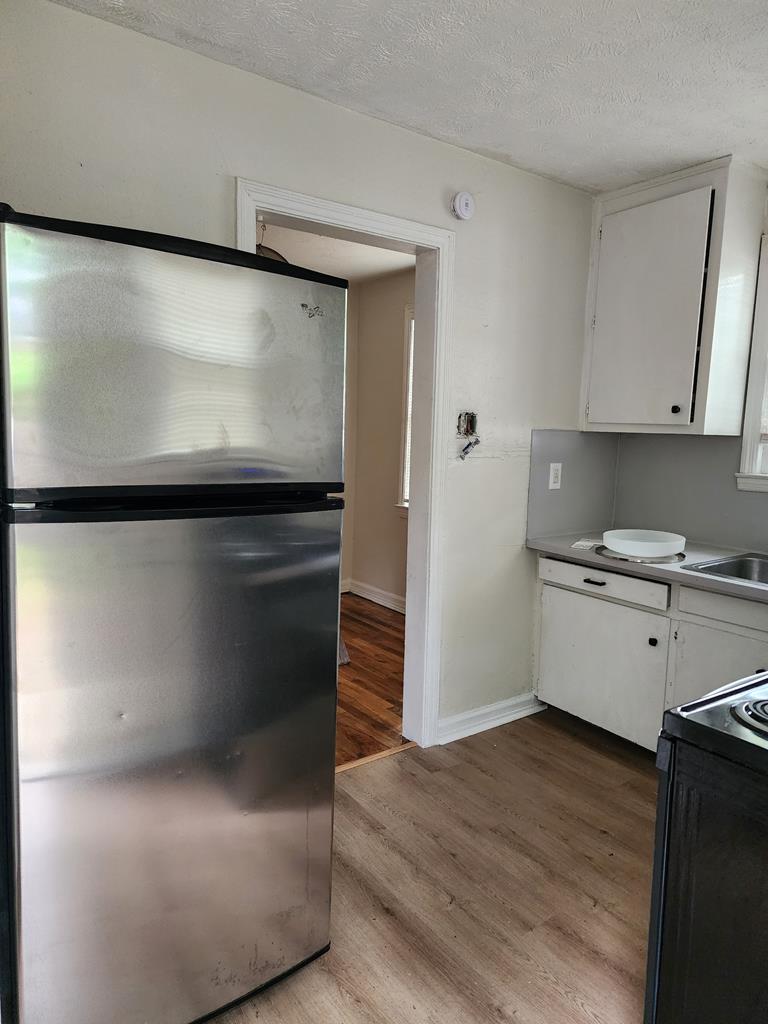 2444 South Lumpkin Road Columbus, GA 31903 - Photo 18 of 21 a kitchen with granite countertop white cabinets and white appliances