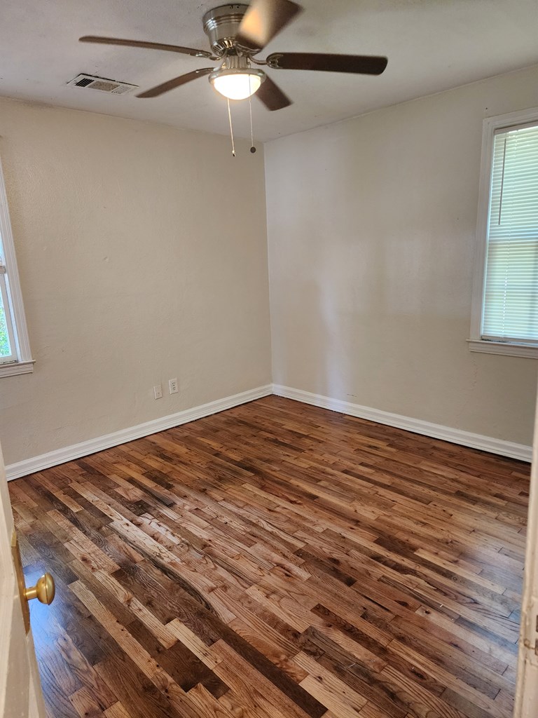 2444 South Lumpkin Road Columbus, GA 31903 - Photo 6 of 21 a view of empty room with wooden floor and fan
