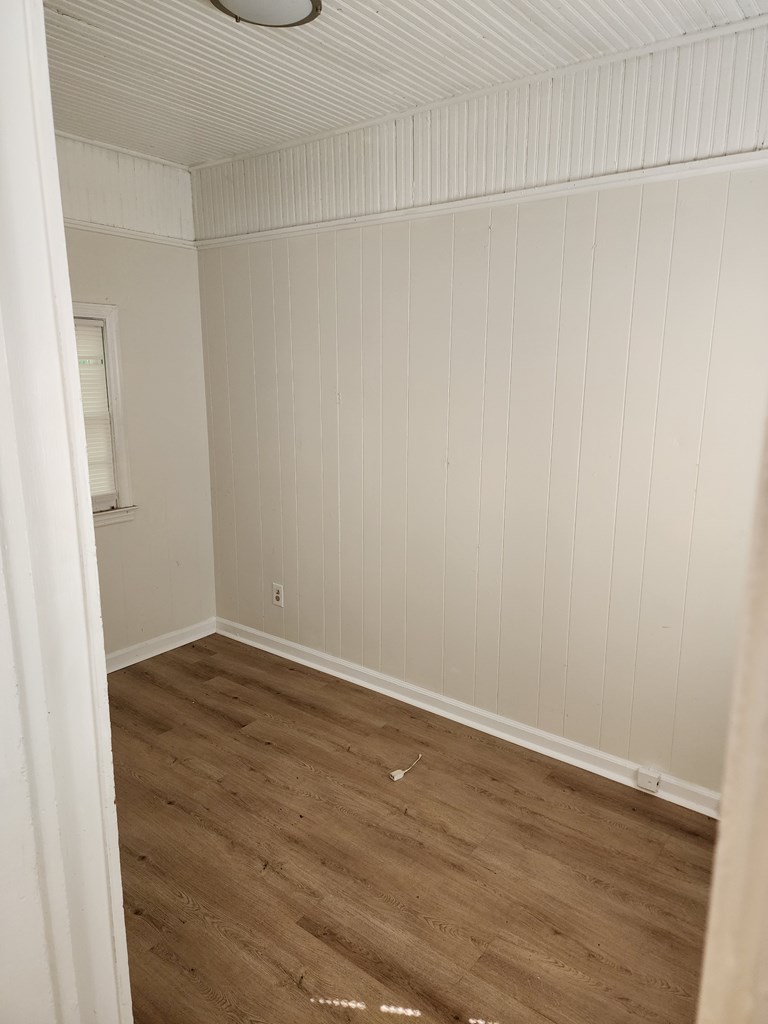 2444 South Lumpkin Road Columbus, GA 31903 - Photo 8 of 21 a view of an empty room with wooden floor
