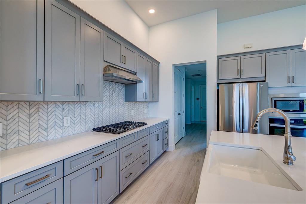 8218 Nevis Run Lakewood Ranch, FL 34202 - Photo 13 of 48 a kitchen with stainless steel appliances granite countertop a sink stove and refrigerator