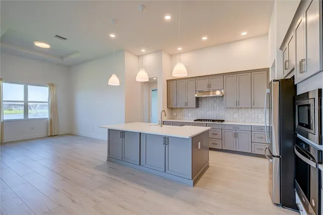 a kitchen with a sink cabinets and wooden floor