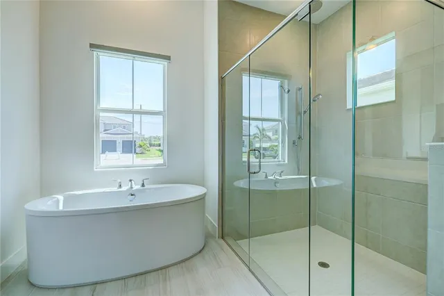 a bathroom with a bathtub and mirror