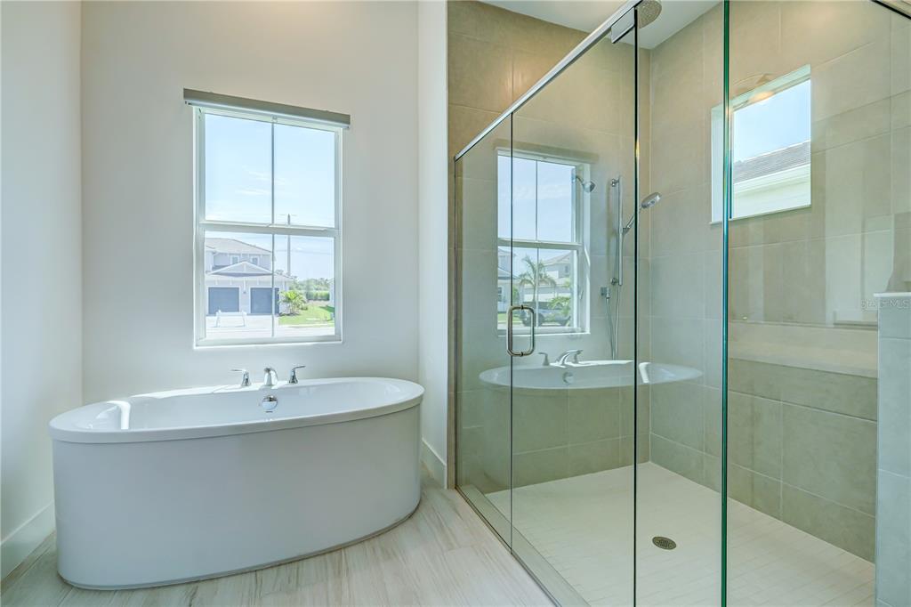 8218 Nevis Run Lakewood Ranch, FL 34202 - Photo 20 of 48 a bathroom with a bathtub and mirror