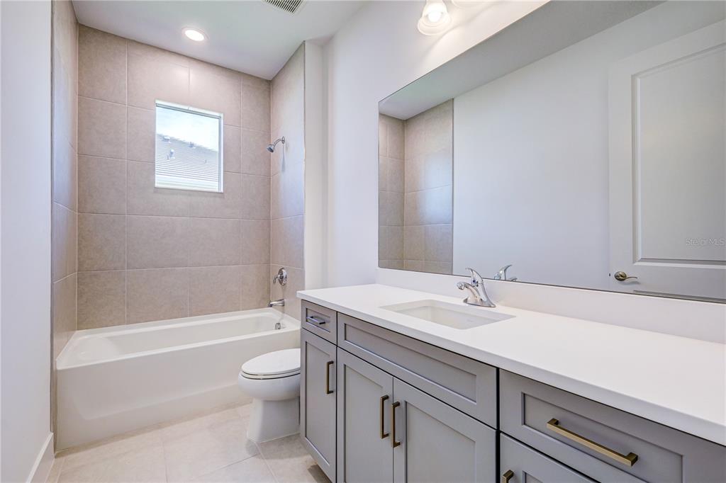 8218 Nevis Run Lakewood Ranch, FL 34202 - Photo 27 of 48 a bathroom with a sink a toilet and shower