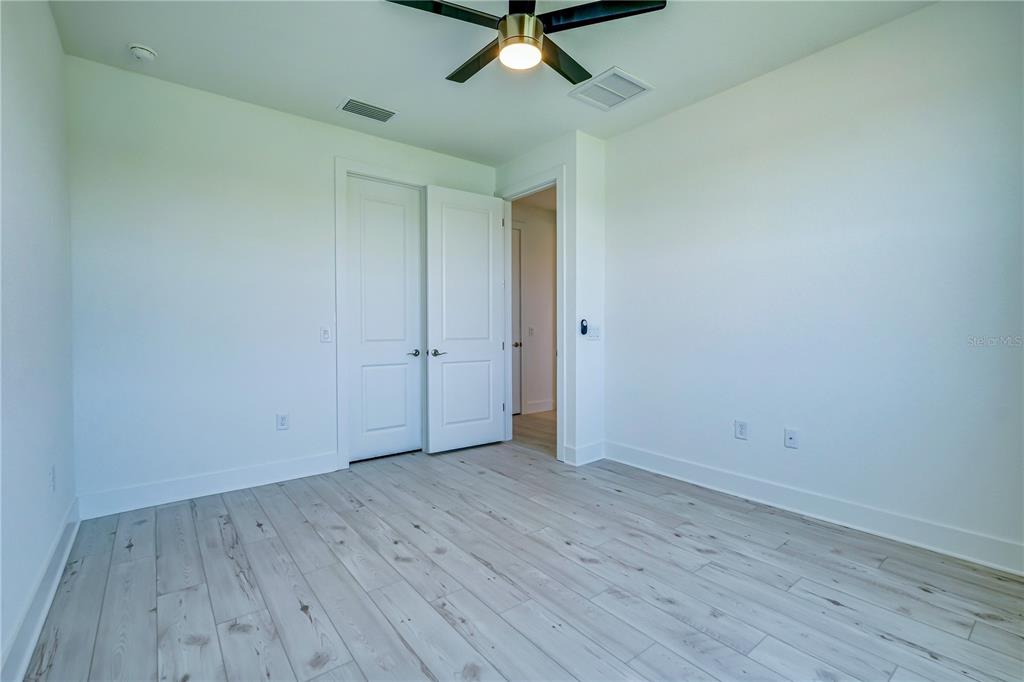 8218 Nevis Run Lakewood Ranch, FL 34202 - Photo 29 of 48 wooden floor in an empty room