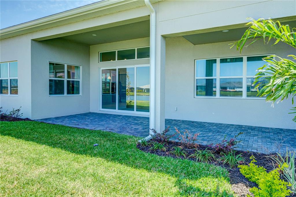 8218 Nevis Run Lakewood Ranch, FL 34202 - Photo 32 of 48 a view of front door of house and yard