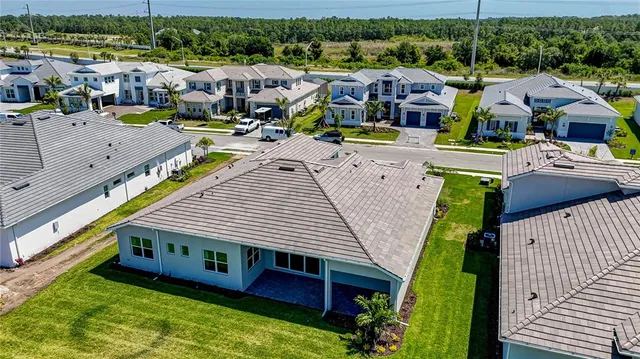 an aerial view of a house with garden space and lake view