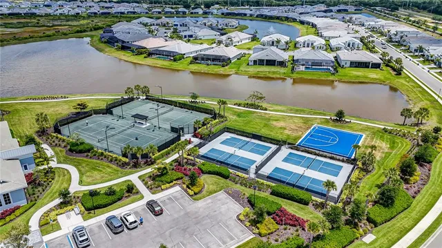 an aerial view of a house with a swimming pool outdoor seating and yard
