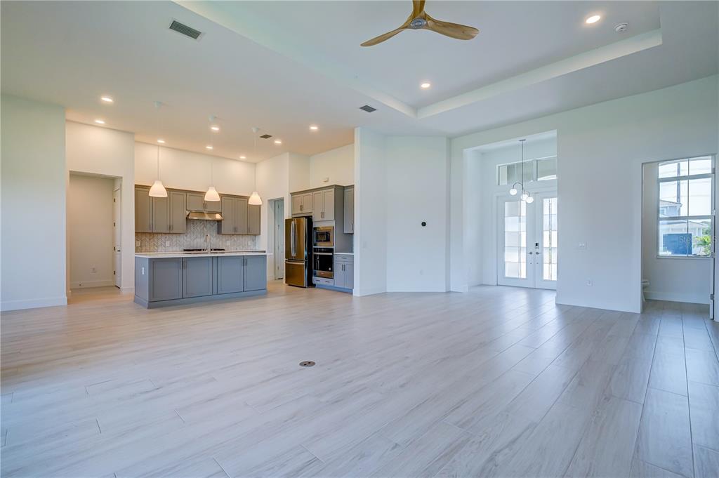 8218 Nevis Run Lakewood Ranch, FL 34202 - Photo 10 of 48 a view of kitchen and hall with wooden floor