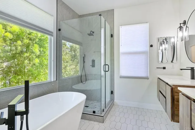 a bathroom with a granite countertop sink a large mirror and a bathtub