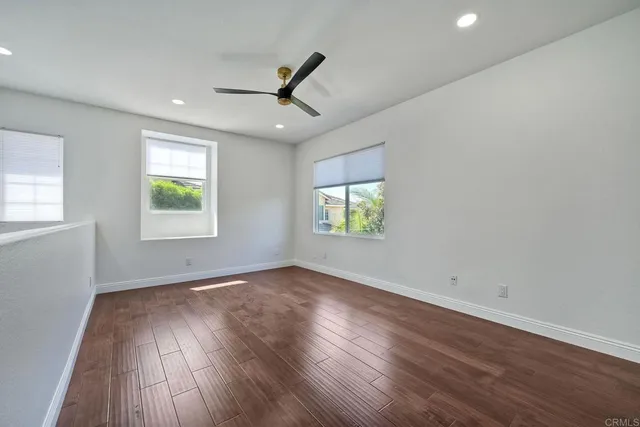 wooden floor in an empty room with a window