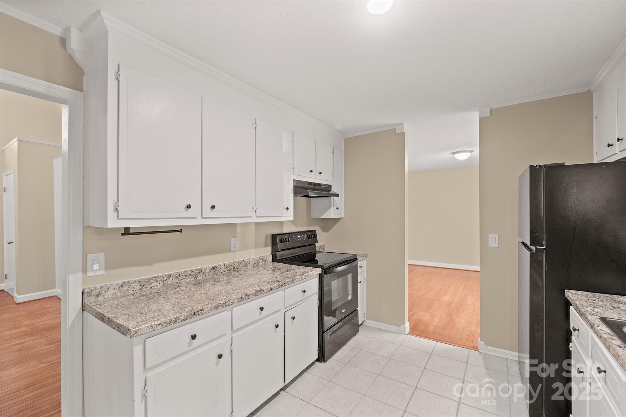 1052 Palmyra Drive Fort Mill, SC 29708 - Photo 12 of 26 a kitchen with granite countertop a refrigerator sink and cabinets