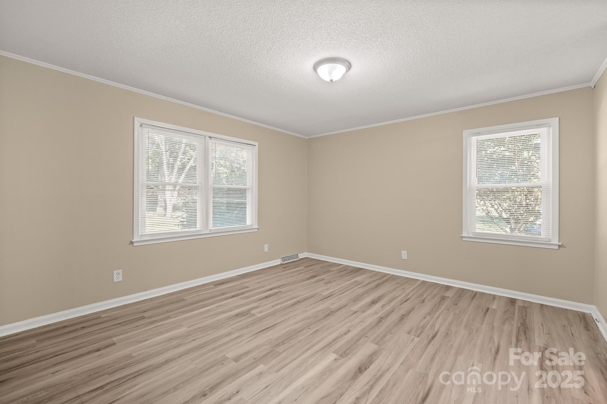 1052 Palmyra Drive Fort Mill, SC 29708 - Photo 14 of 26 a view of an empty room with wooden floor and a window