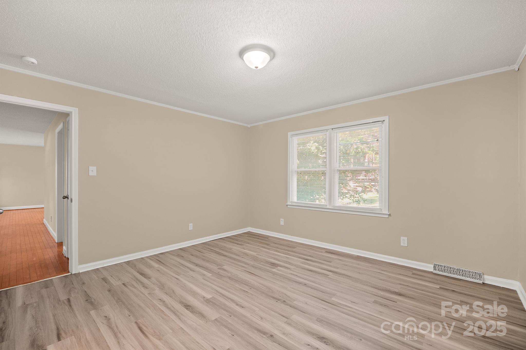 1052 Palmyra Drive Fort Mill, SC 29708 - Photo 16 of 26 an empty room with wooden floor and windows