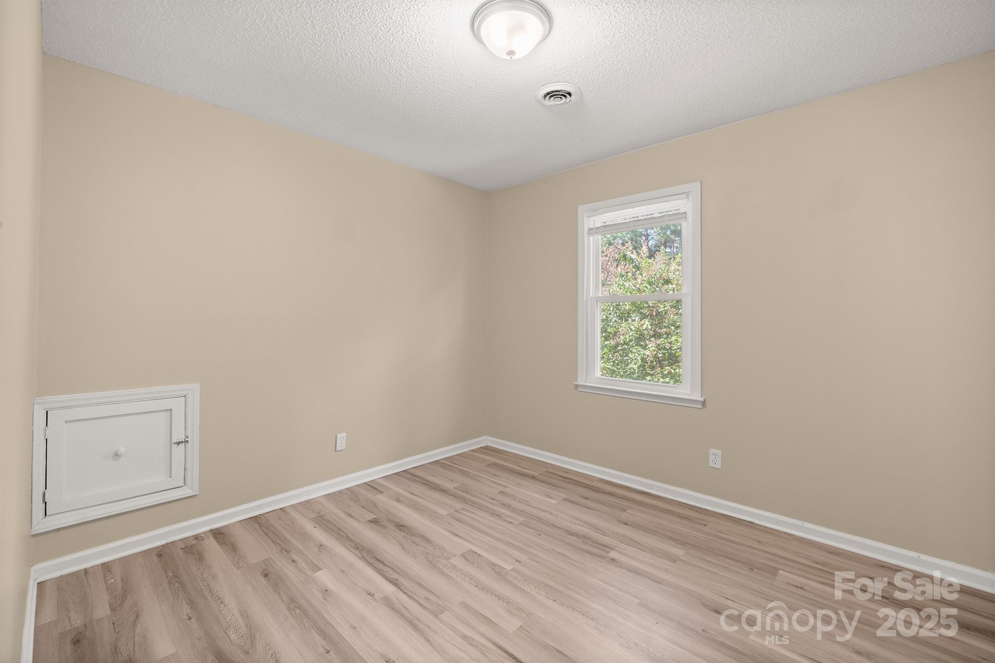 1052 Palmyra Drive Fort Mill, SC 29708 - Photo 21 of 26 an empty room with wooden floor and windows