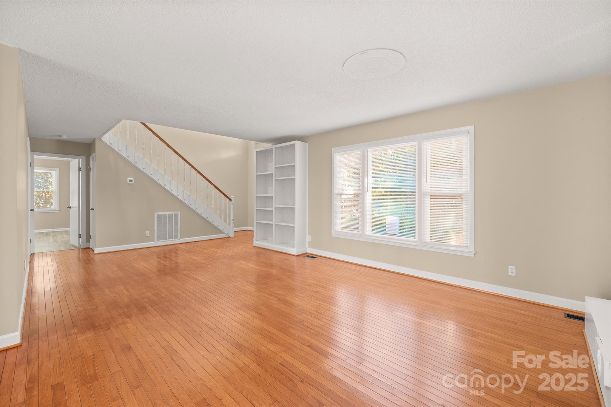 1052 Palmyra Drive Fort Mill, SC 29708 - Photo 6 of 26 a view of an empty room with wooden floor and a window