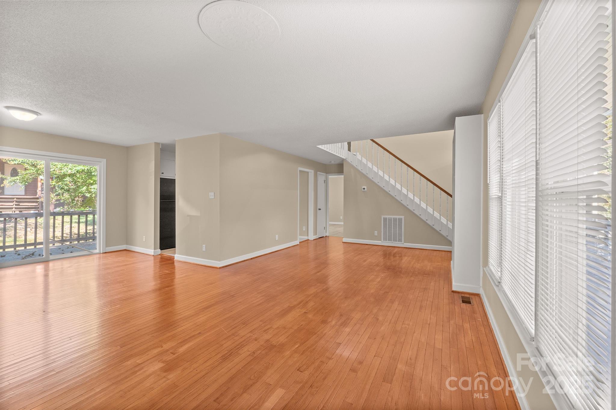 1052 Palmyra Drive Fort Mill, SC 29708 - Photo 7 of 26 wooden floor in an empty room with a window