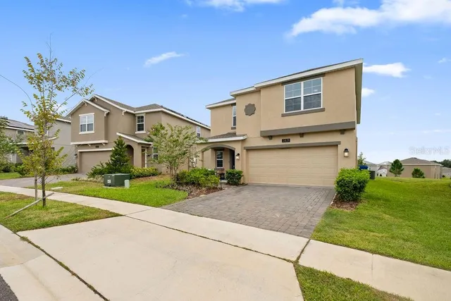 a front view of a house with a yard and garage