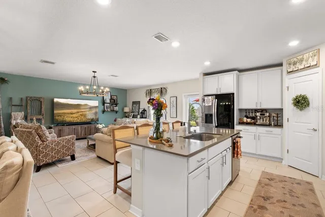 a kitchen with stainless steel appliances kitchen island granite countertop a sink and cabinets