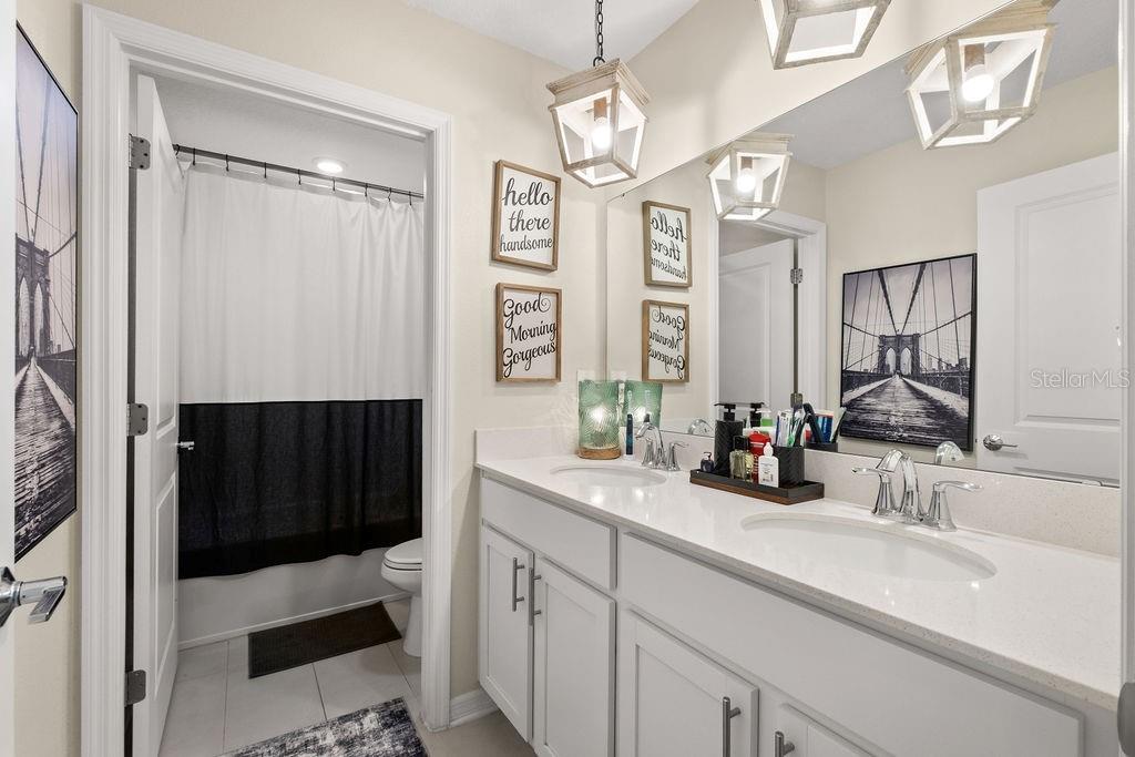 2821 Muller Oak Loop Ocoee, FL 34761 - Photo 24 of 45 a bathroom with a sink a toilet a mirror and shower